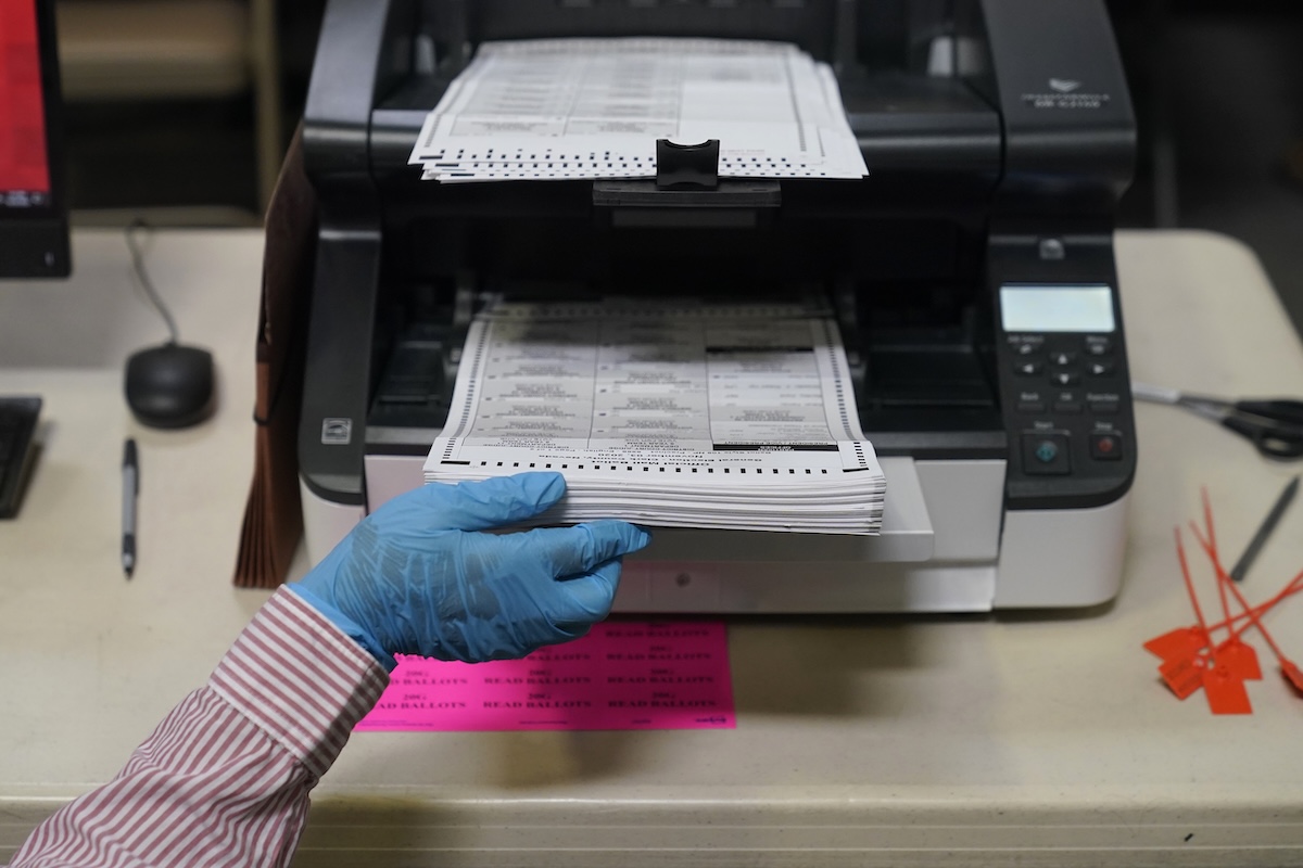 Hand placing ballots into machine in Las Vegas