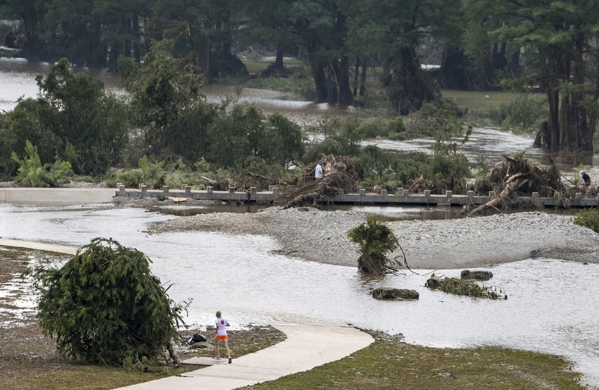 Flooded Guadalupe River in Kerrville Texaswith jogger