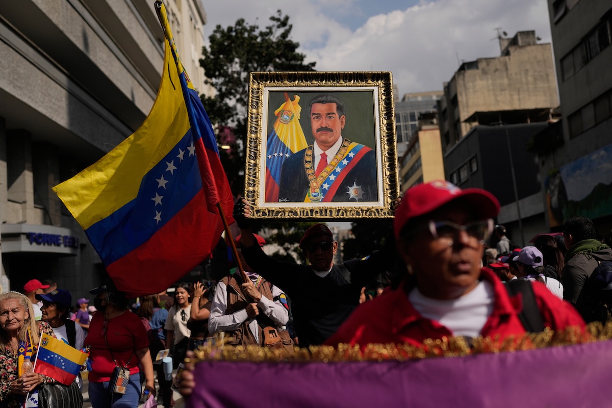 Protester holding portrait of Maduro in Caracas march