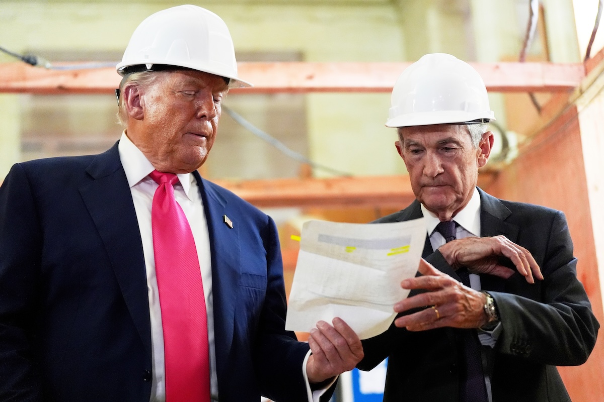 Jerome Powell and Donald Trump wearing hard hats at Fed building