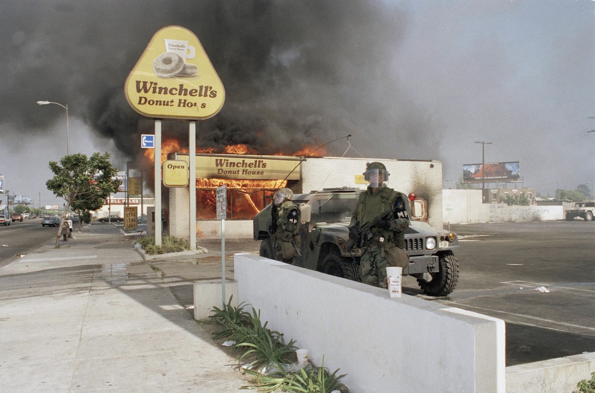 Rodney King riots, National Guard in front of a burning building 04-30-1992