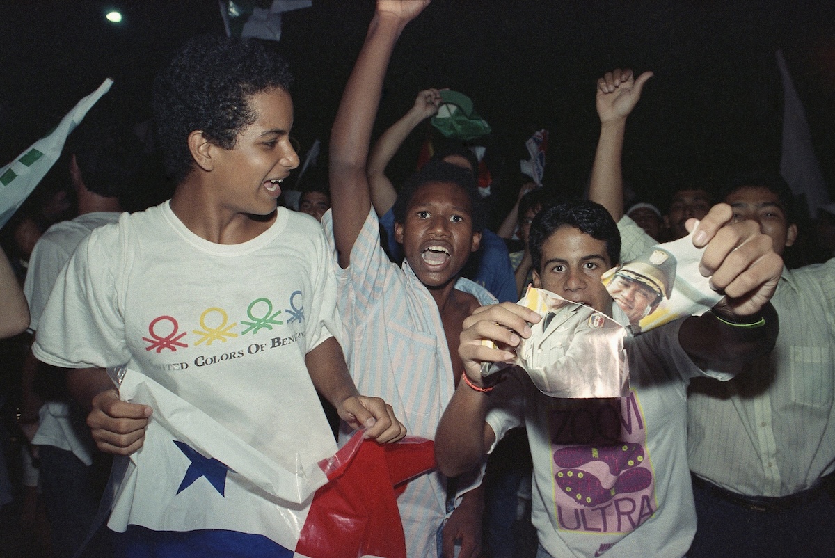 Protester rips up Noriega photo in protest