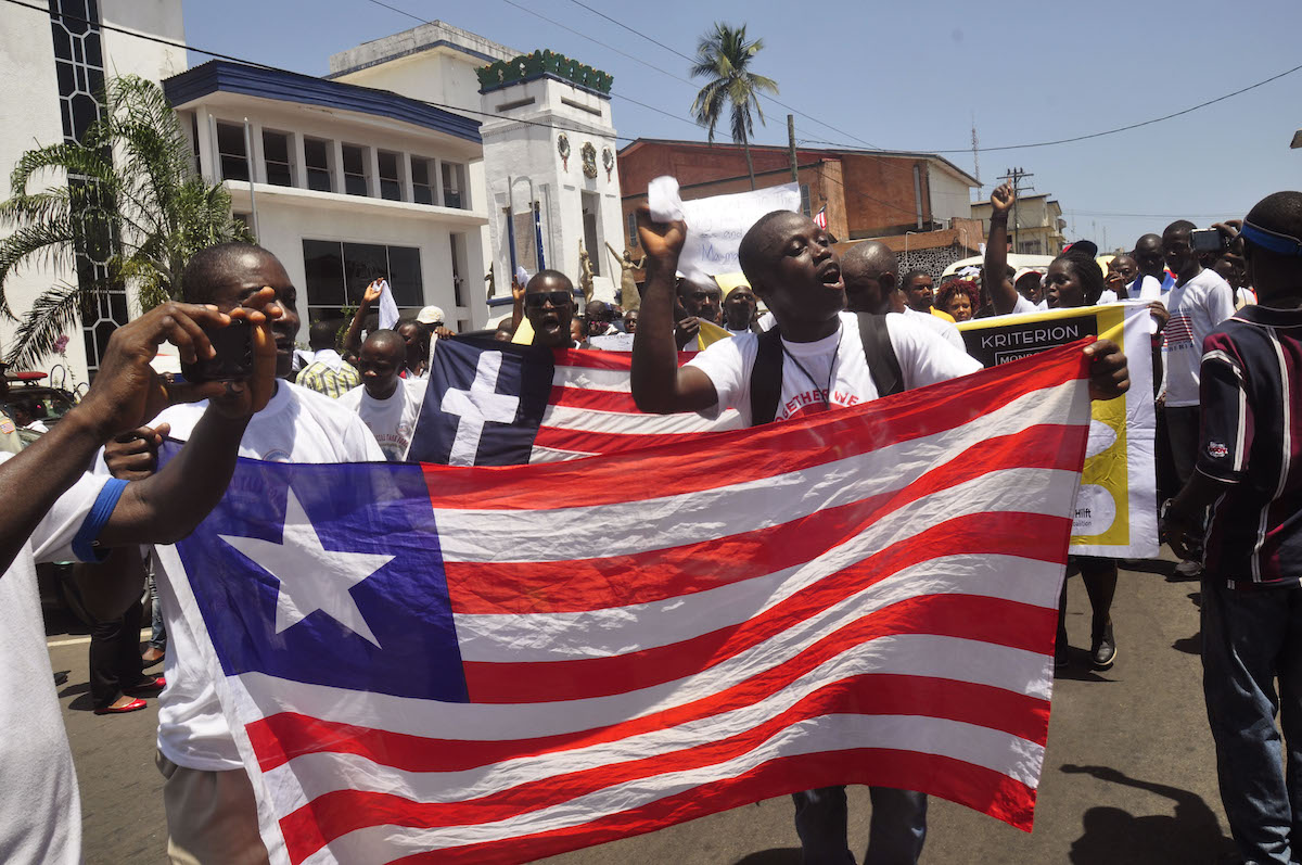 People holding Liberian flag in 2015 post Ebola