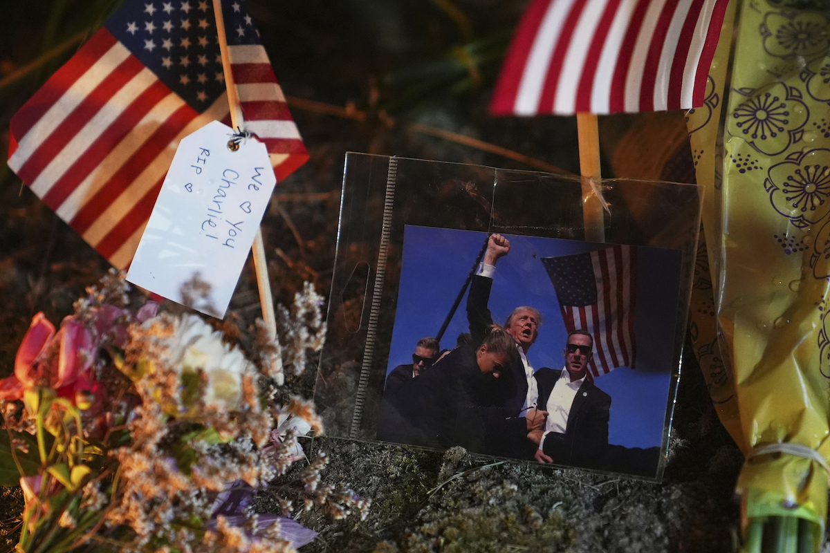 Charlie Kirk memorial with flags and Trump photo 9-10-25
