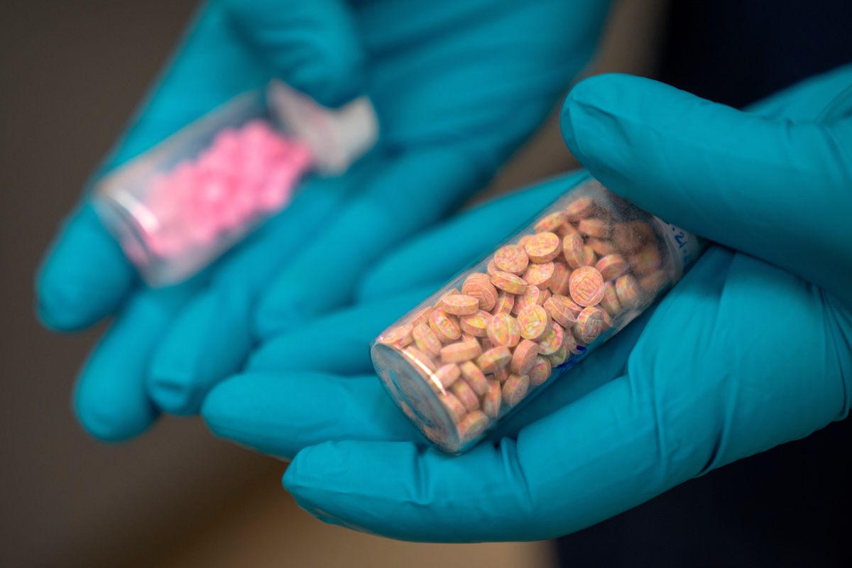 DEA scientists hold vials of fentanyl pills April 29, 2025