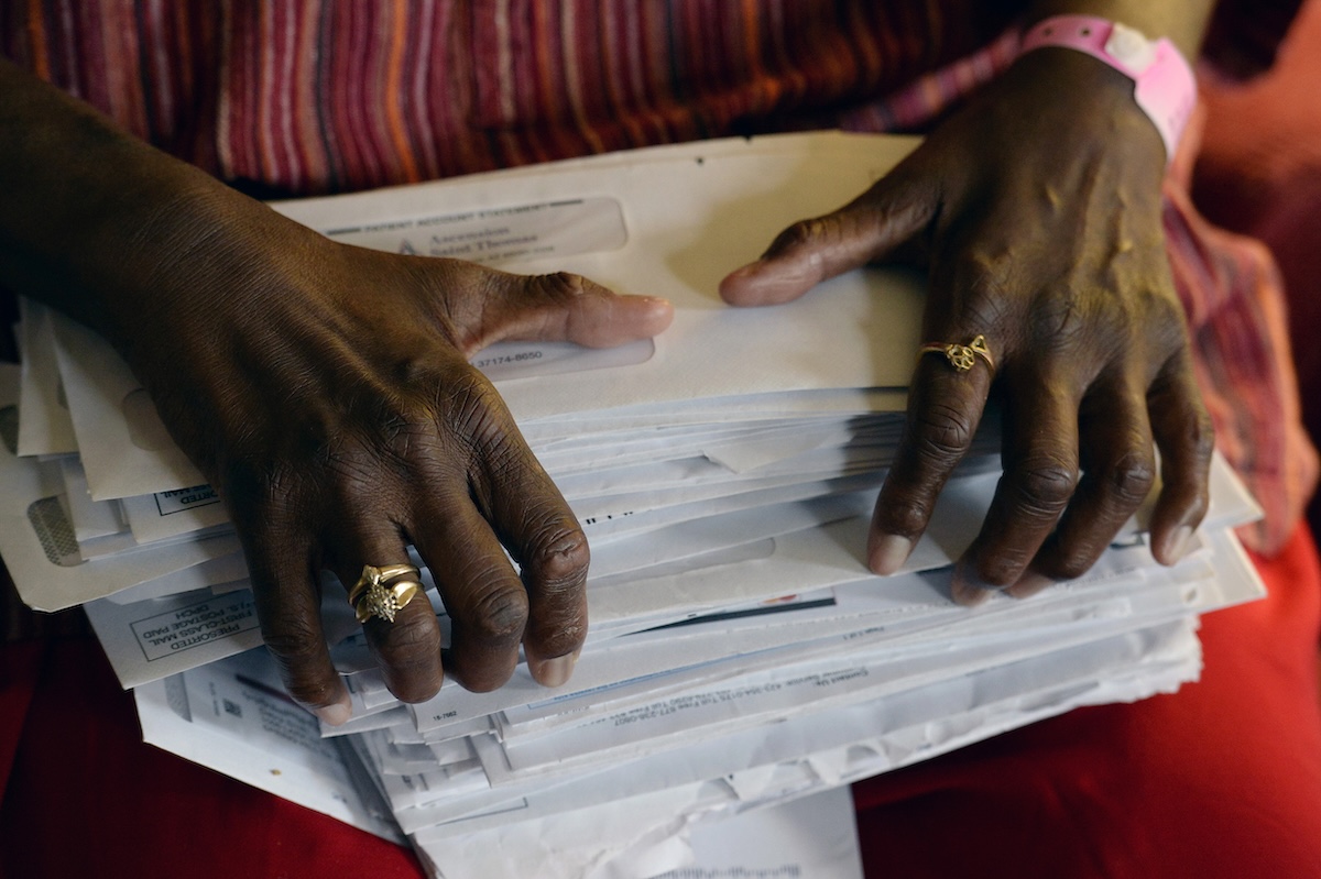 Debra Smith holds medical bills in 2021 in Tennessee