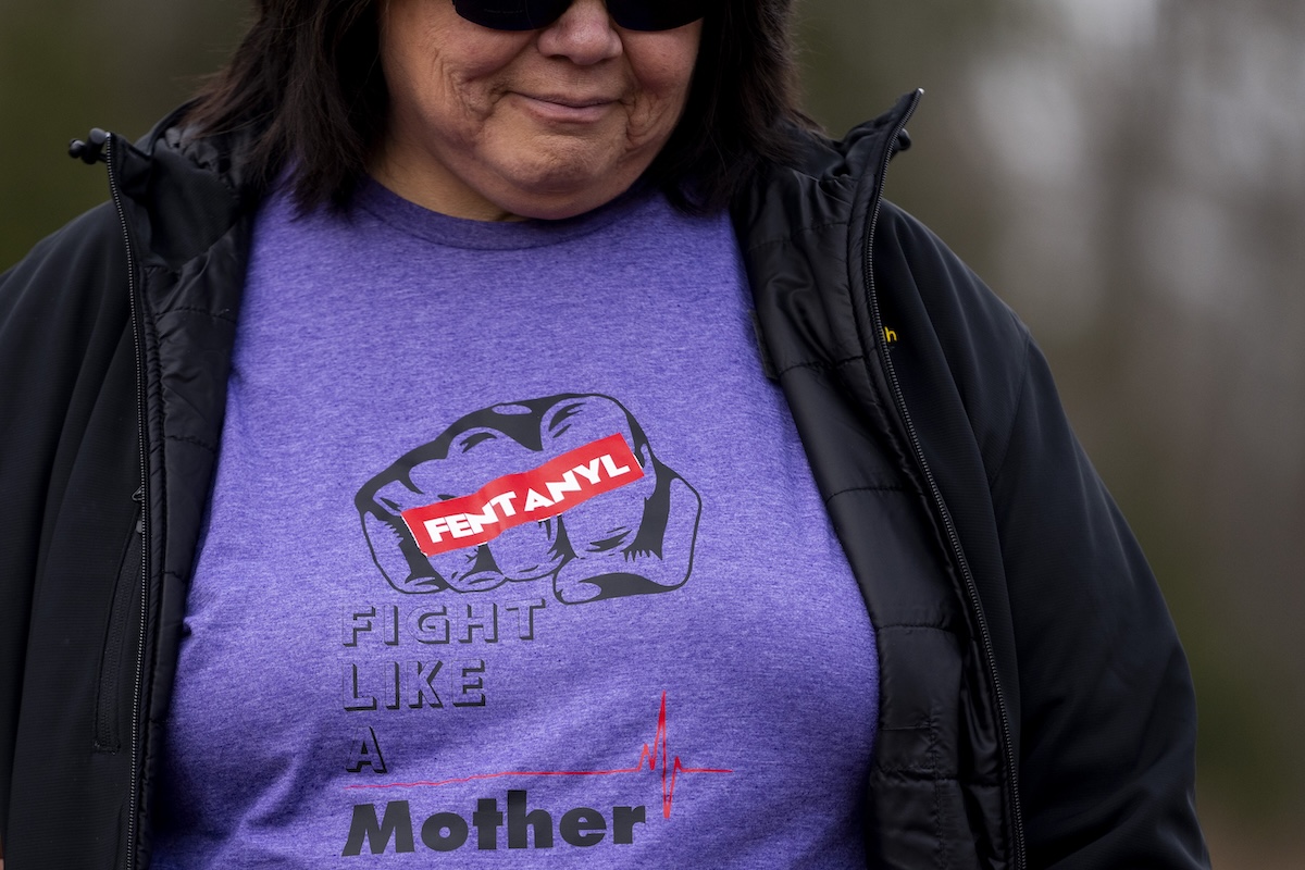 Mother in fentanyl "fight like a mother" shirt near her sons grave Feb. 8, 2024
