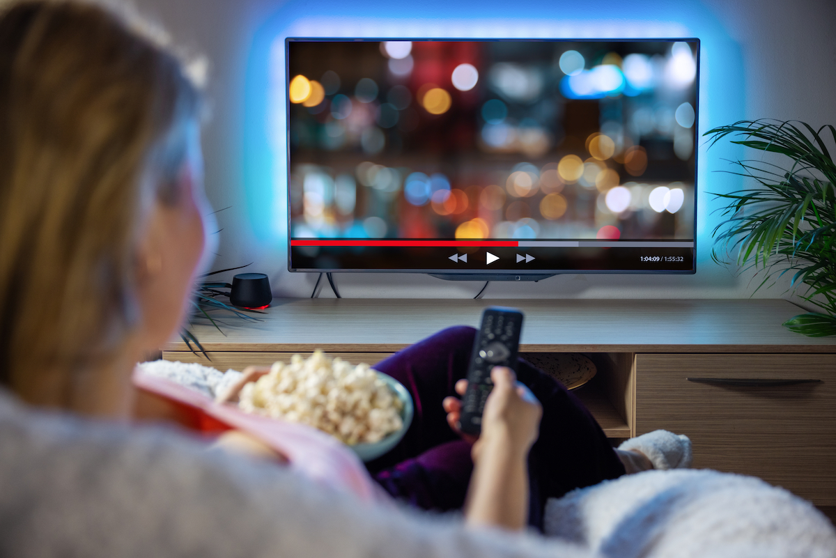 Woman streams Netflix with popcorn