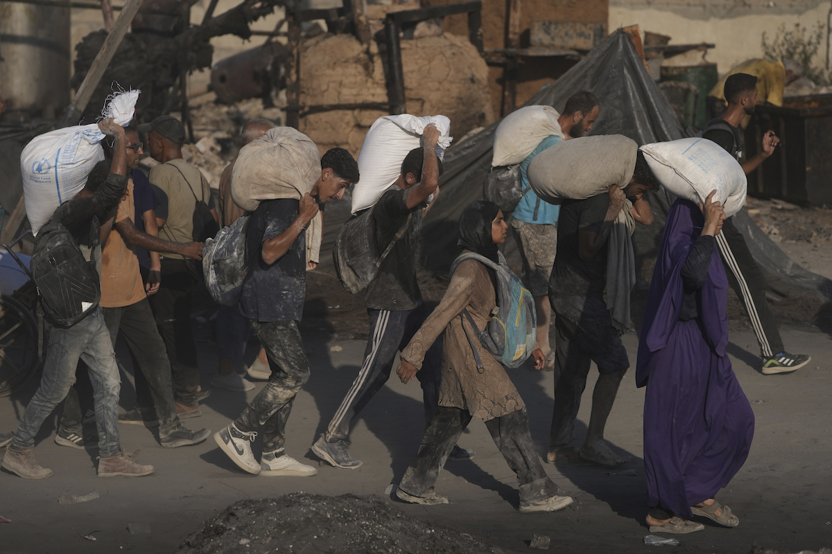 Palestinians carry sacks of flour 7/26/25