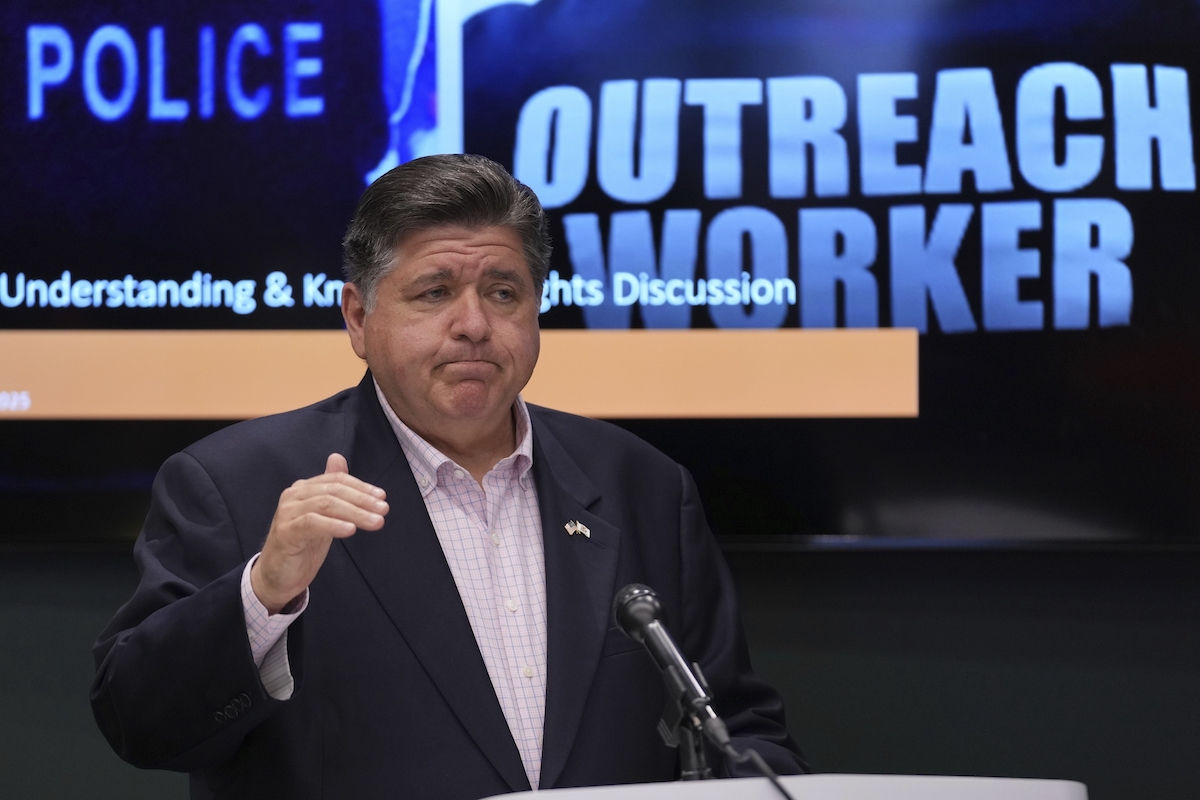 Gov JB Pritzker with police sign Chicago 9-3-25