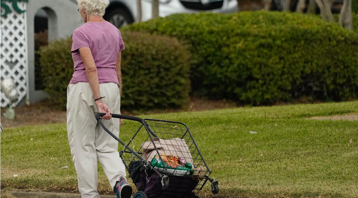older woman with grocery roll cart