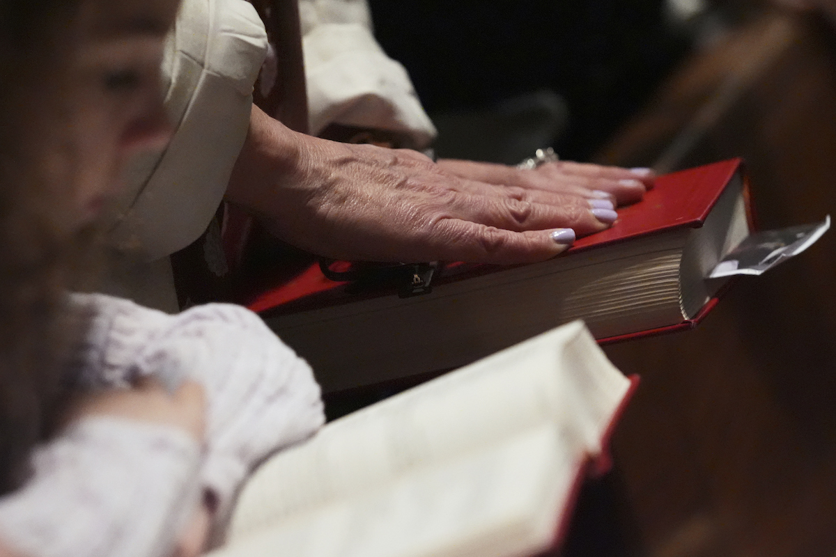 Photo of woman touching Bible 05-11-25