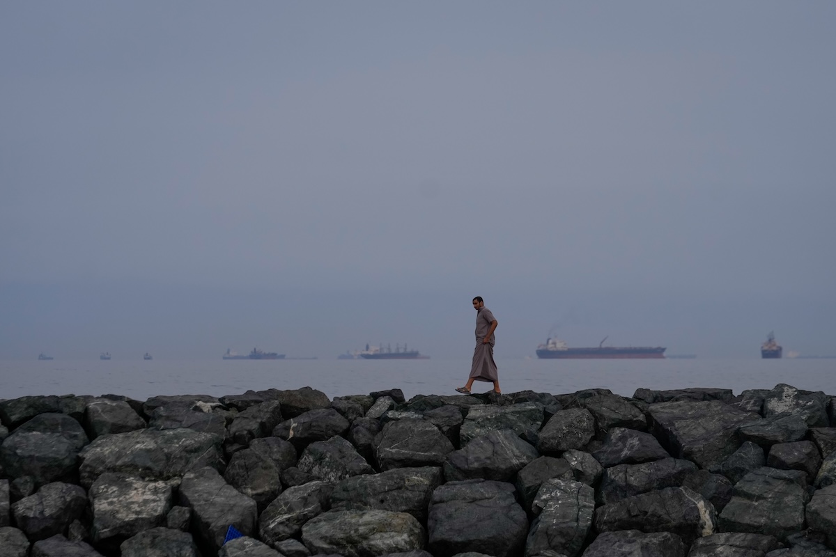 Man walking alongside strait of hormuz