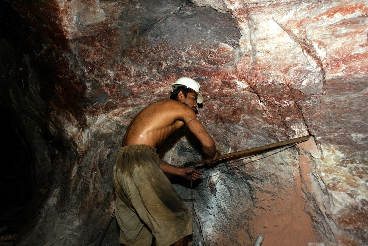 A miner digs pink Himalayan salt at Khwera mine in Pakistan Jan. 15, 2005