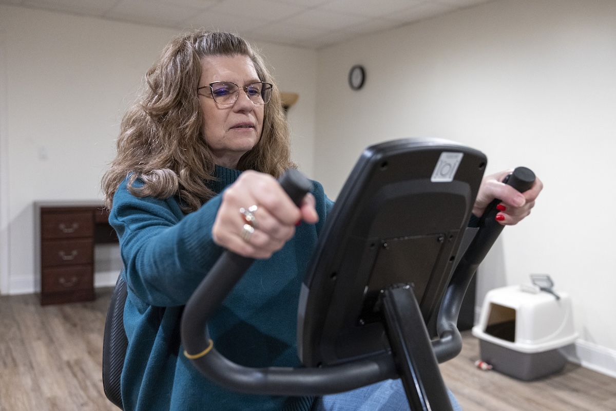 Woman on exercise bike one GLP-1s March 2024