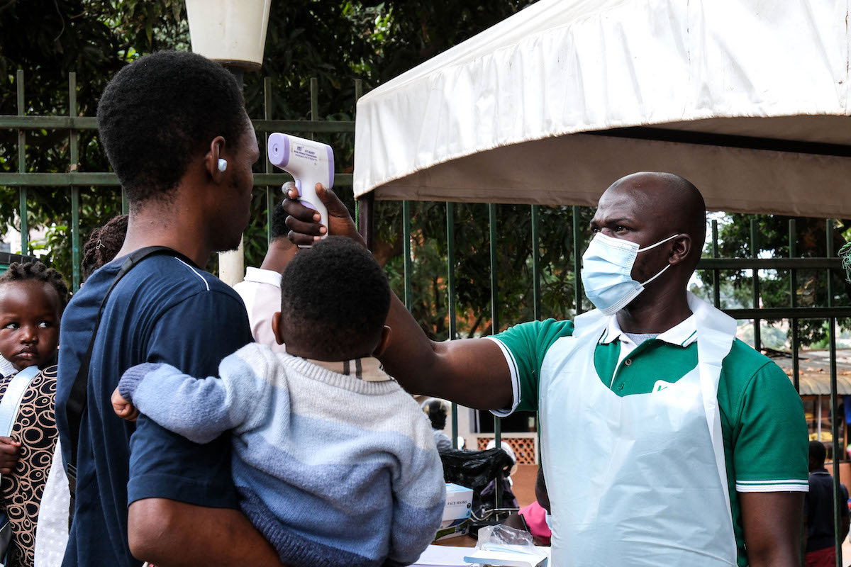 Health worker uses thermometer in Uganda Ebola 2026