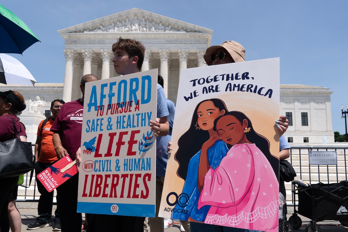 birthright citizenship activists with signs 6-30-26