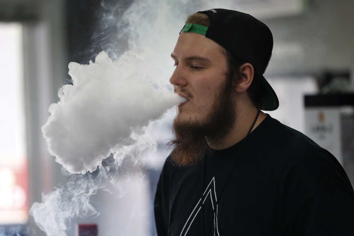 Vape shop manager blows aerosol ring while vaping 09-03-2019